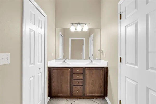 a view of a bathroom with a granite countertop sink and a mirror