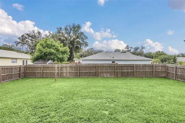 a view of a backyard with a garden and entertaining space