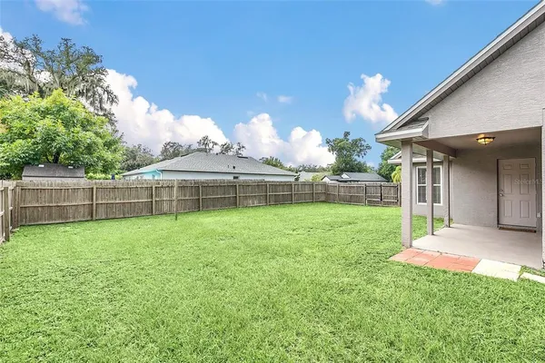 a view of a backyard with a garden and entertaining space