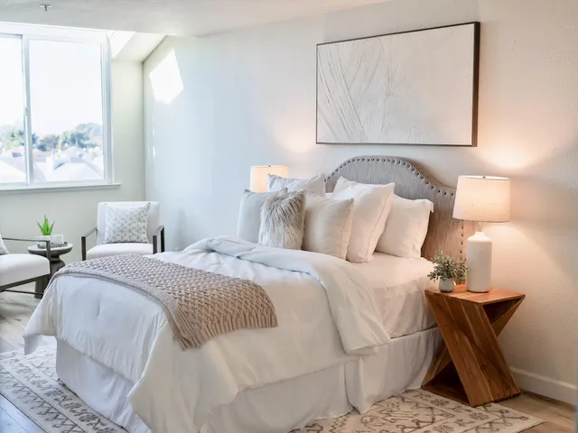 a bedroom with furniture and a potted plant