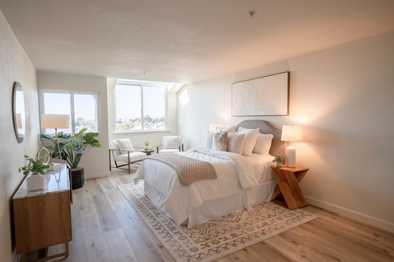 160 Seascape Ridge Drive Aptos, CA 95003 - Photo 13 of 61 a bedroom with a bed potted plant on dresser and a wooden floor