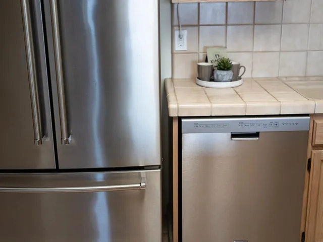 a kitchen with stainless steel appliances granite countertop a refrigerator stove a sink and microwave