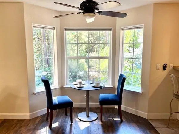 a view of a dining room with furniture window and wooden floor