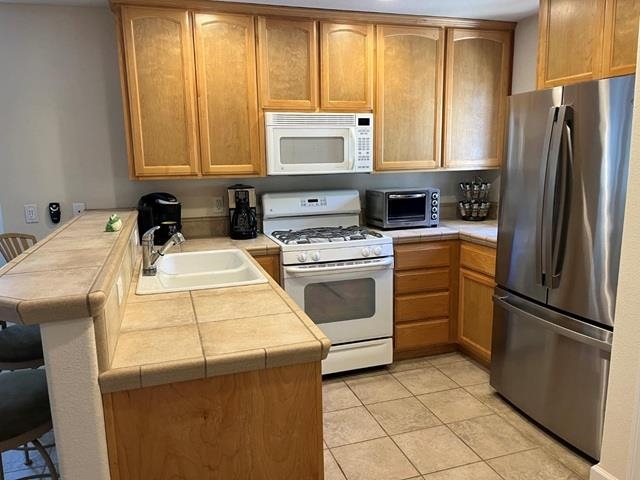 311 Fairway Drive Murphys, CA 95247 - Photo 6 of 15 a kitchen with a refrigerator sink and cabinets