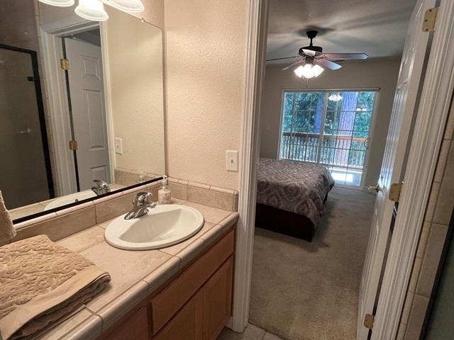 311 Fairway Drive Murphys, CA 95247 - Photo 10 of 15 a en suite bathroom with a granite countertop sink and a mirror