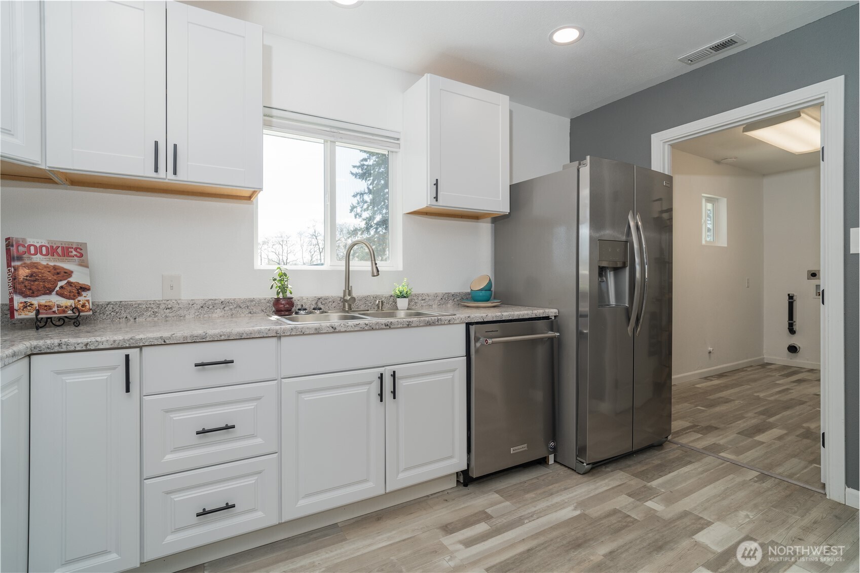 10327 185th Avenue Southwest Rochester, WA 98579 - Photo 11 of 27 a kitchen with granite countertop cabinets stainless steel appliances a sink and a window