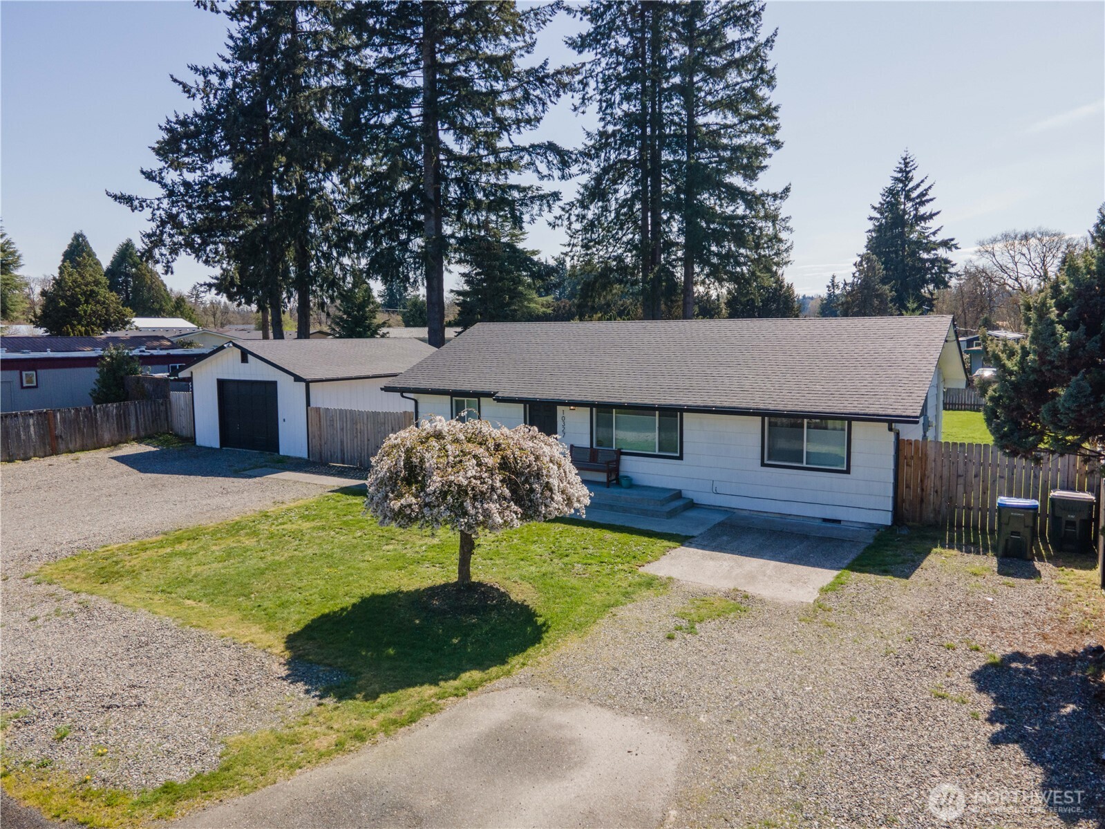 10327 185th Avenue Southwest Rochester, WA 98579 - Photo 4 of 27 a front view of a house with a yard and garage