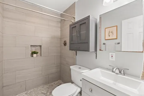 a bathroom with a toilet sink and mirror