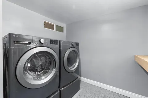 a utility room with sink dryer and washer