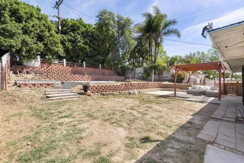 a backyard of a house with lots of green space and trees