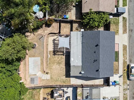 aerial view of a house with backyard and sitting area