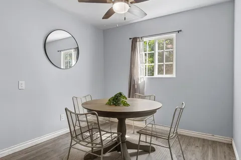 a view of a dining room with furniture and chandelier