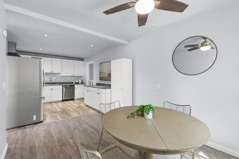 a view of a kitchen with kitchen island a sink stainless steel appliances and cabinets