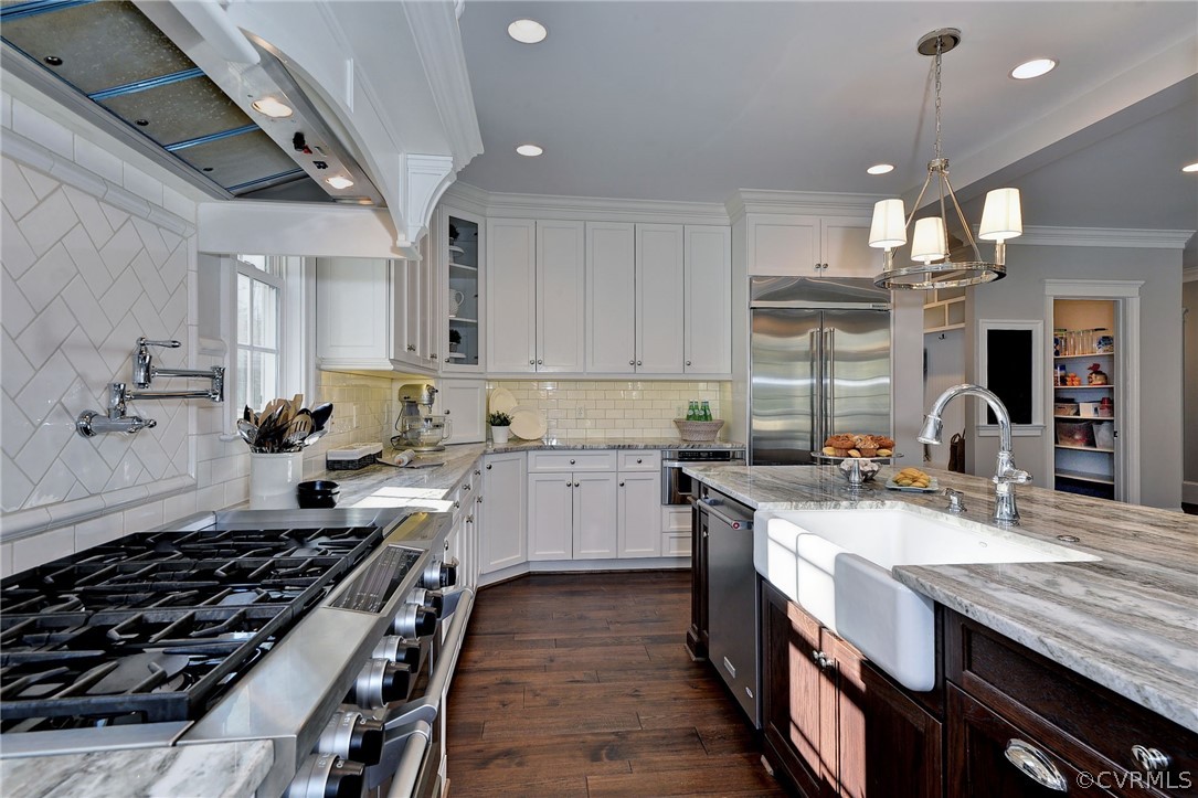 3419 Westport Williamsburg, VA 23188 - Photo 15 of 50 a kitchen with kitchen island granite countertop a sink stove and cabinets