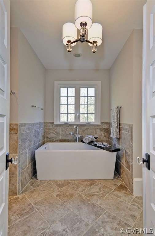 3419 Westport Williamsburg, VA 23188 - Photo 26 of 50 a bathroom with a tub sink and a chandelier