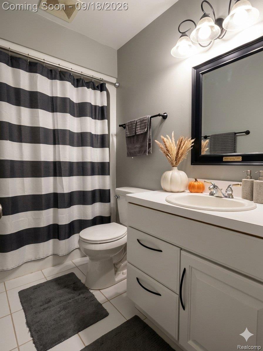 7070 Elms Road Swartz Creek, MI 48473 - Photo 20 of 27 White vanity with dual drawers, cabinet storage, and a single basin sink