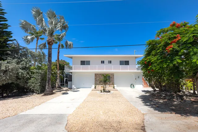 a view of a chair and table in back yard of the house