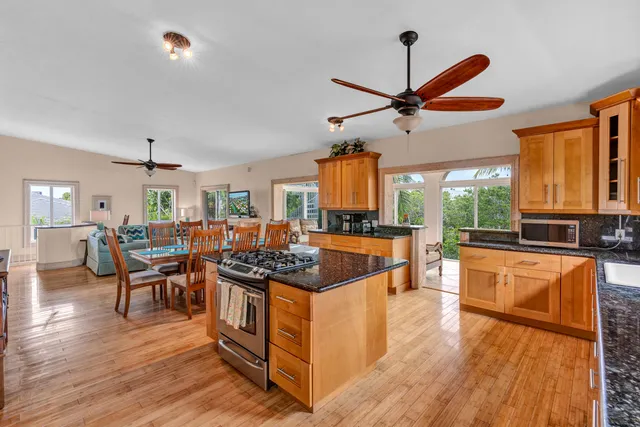 a open kitchen with stainless steel appliances granite countertop a stove and a refrigerator