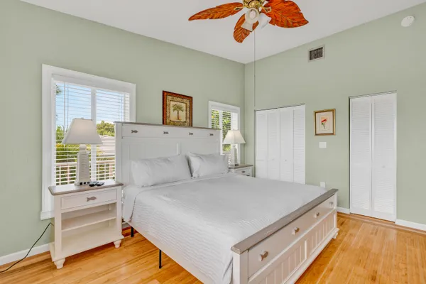 a bedroom with a large bed and a chandelier