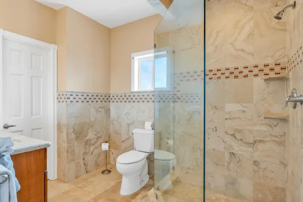 a bathroom with a toilet sink and shower