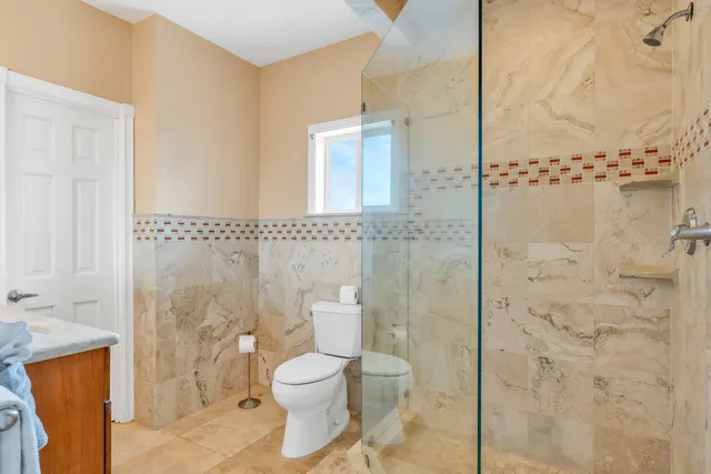 a bathroom with a toilet sink and shower