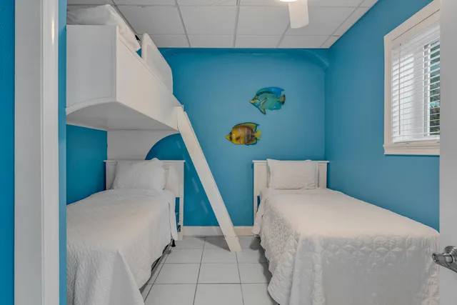 a bedroom with a bed and a painting on the wall