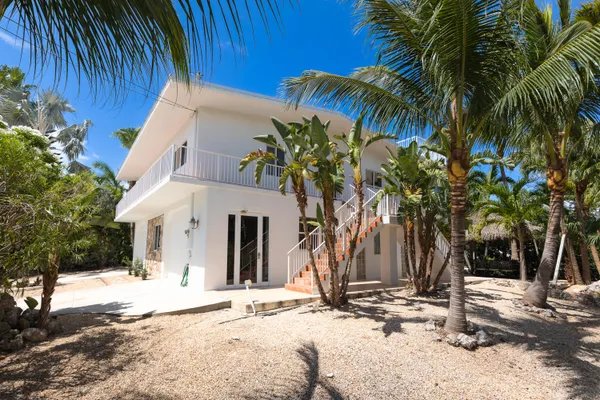a view of a palm trees front of a house