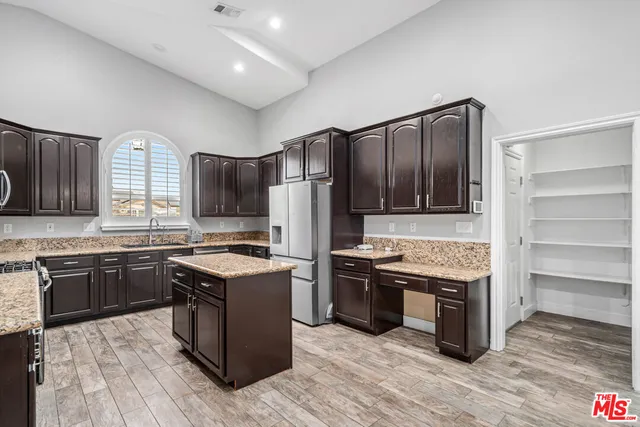 a kitchen with granite countertop stainless steel appliances and wooden cabinets
