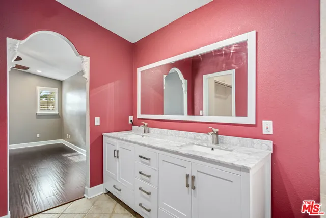 a bathroom with a sink vanity and a mirror
