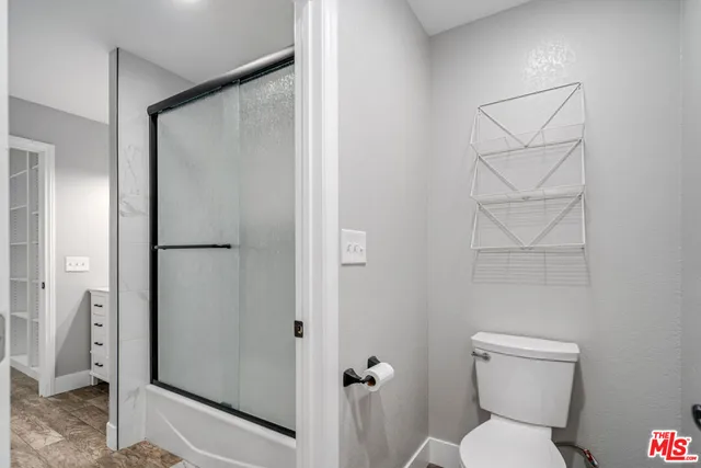 a bathroom with a toilet and a shower