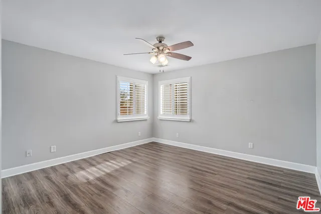 a view of a room with wooden floor and windows