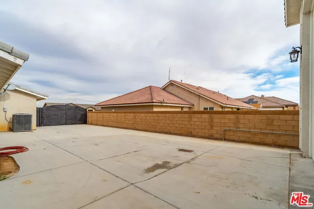a front view of a house with a garden and trees