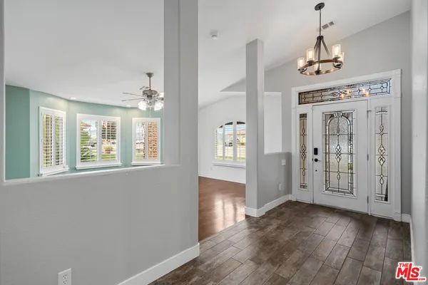 a view of an entryway with wooden floor