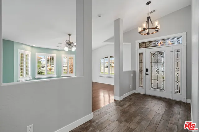 a view of an entryway with wooden floor