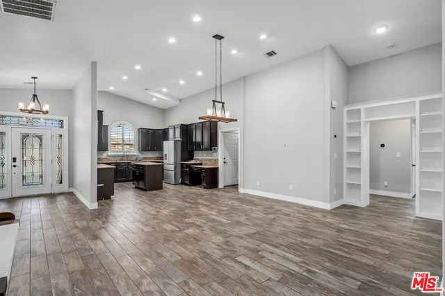 a view of a kitchen with refrigerator and an oven