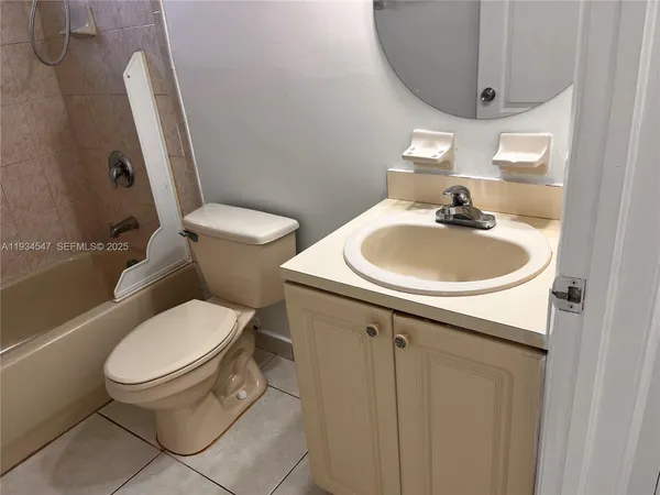 a white toilet sitting next to a bathroom sink