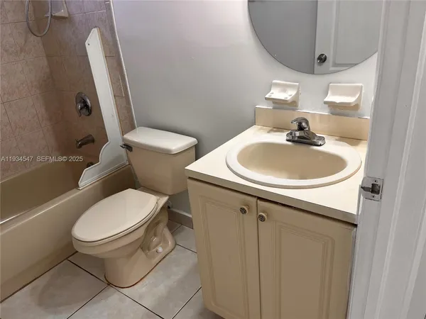 a bathroom with a sink toilet and a mirror