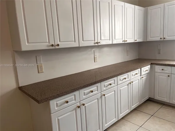 a kitchen with white cabinets