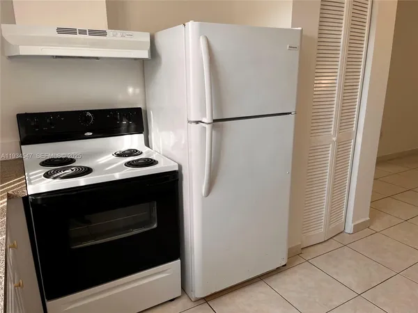 a close view of stove top oven and refrigerator