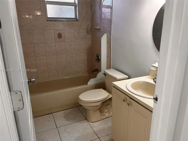 a white toilet sitting next to a bath tub
