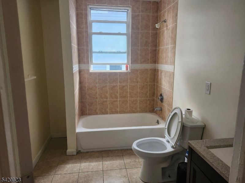313 Leslie Street Newark, NJ 07112 - Photo 6 of 7 a bathroom with a bath tub and a shower