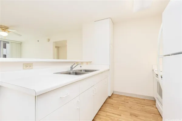 a kitchen with a sink and a refrigerator