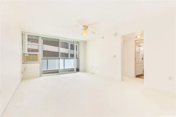 an empty room with windows and cabinet