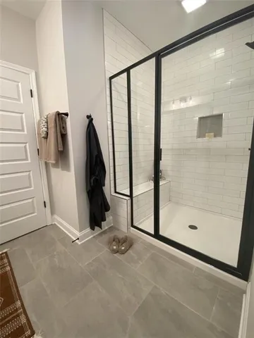 a view of a hallway with a glass door shower