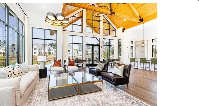 a living room with furniture wooden floor and a large window