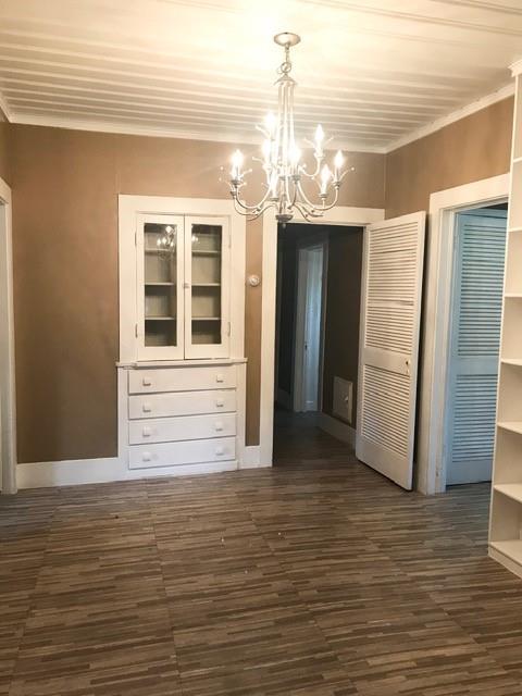 106 West Decatur Street Ennis, TX 75119 - Photo 12 of 17 a view of a room with wooden floor and chandelier