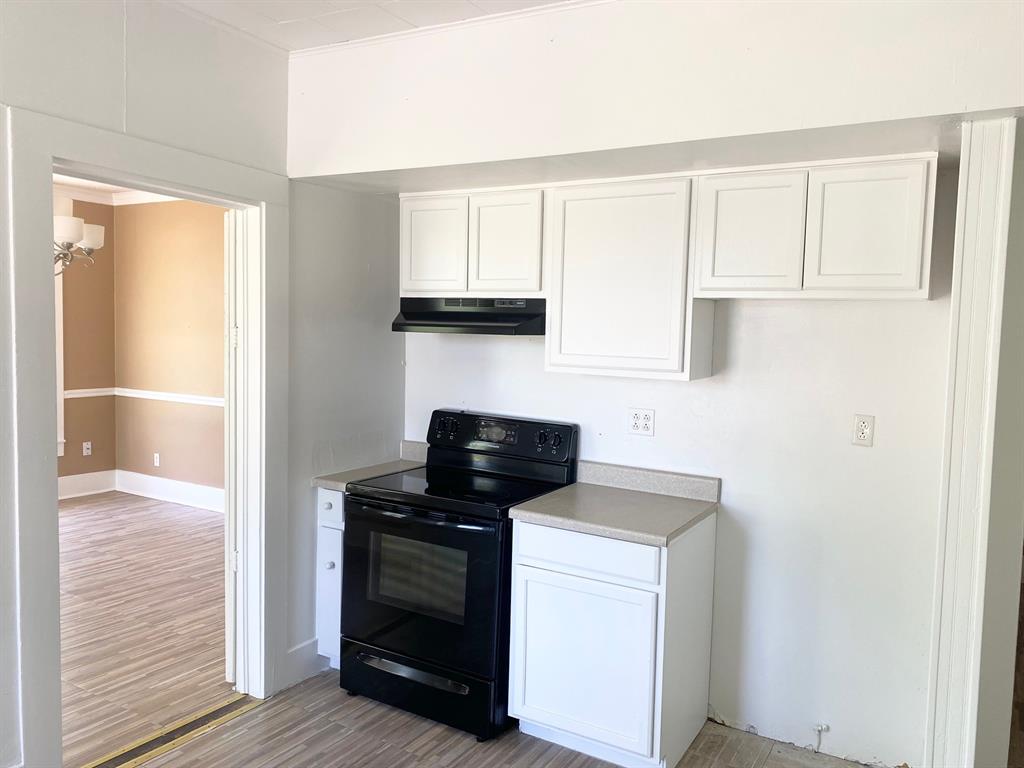 106 West Decatur Street Ennis, TX 75119 - Photo 4 of 17 a view of a kitchen with a sink cabinets and a window