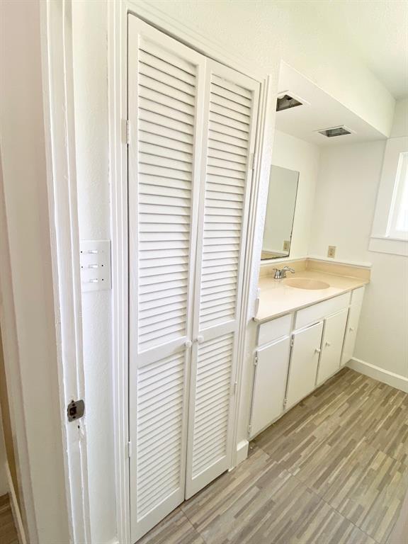 106 West Decatur Street Ennis, TX 75119 - Photo 7 of 17 a view of a kitchen with white wooden cabinets and white appliances