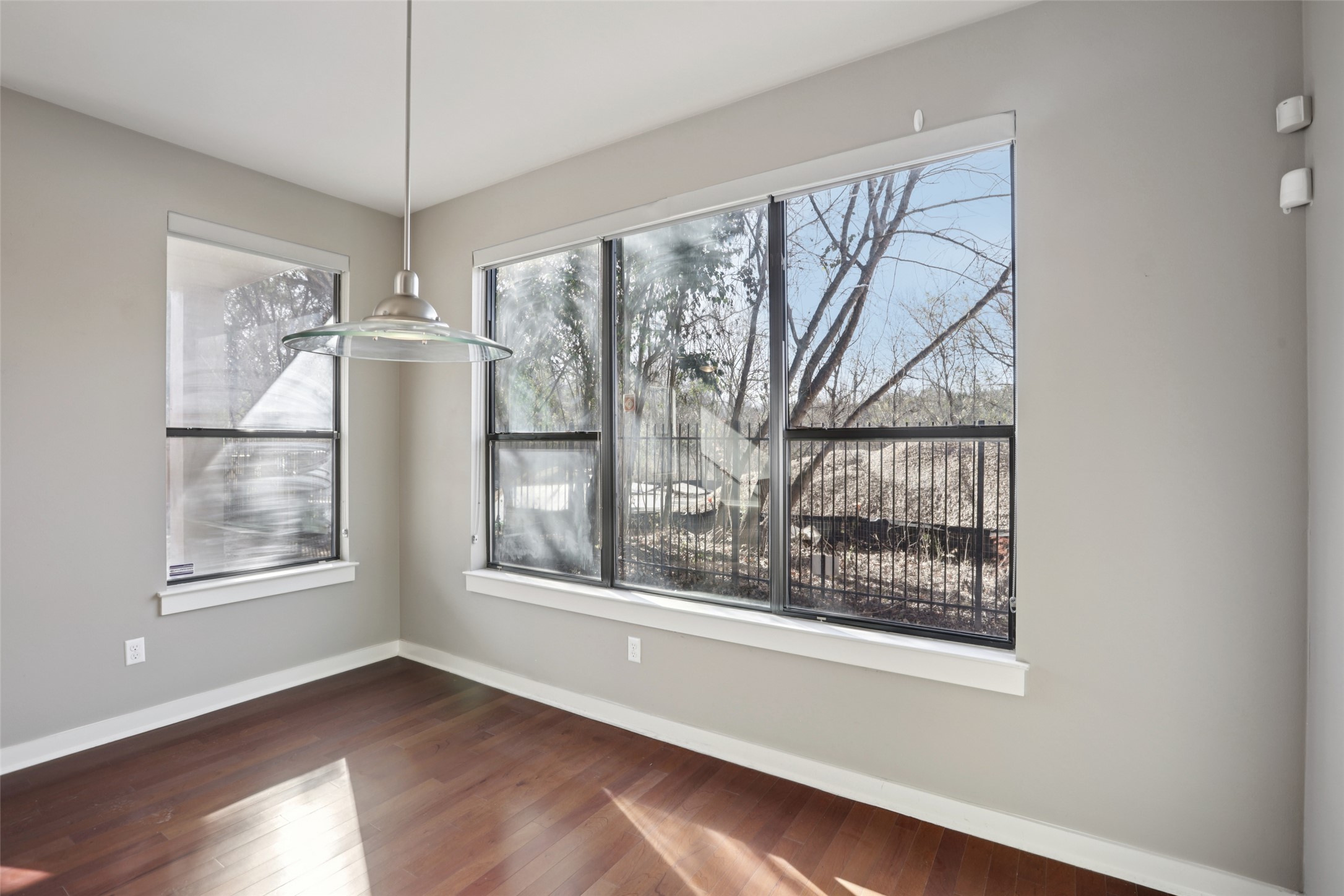 1123 Blair Way Austin, TX 78704 - Photo 9 of 25 a view of an empty room with a window and wooden floor