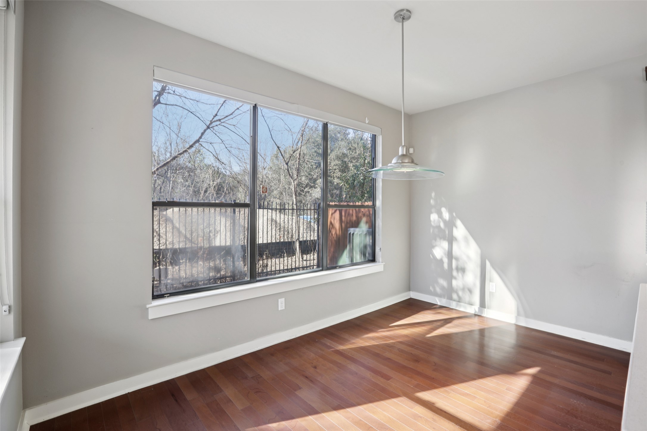 1123 Blair Way Austin, TX 78704 - Photo 12 of 30 Unfurnished dining area with hardwood / wood-style flooring and baseboards